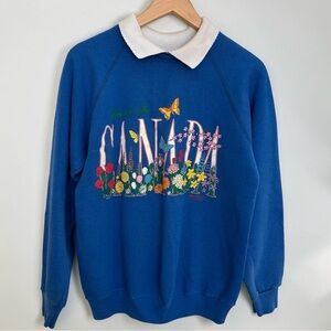 Vintage Blue Crewneck Sweatshirt with Floral 'Canada' Graphic